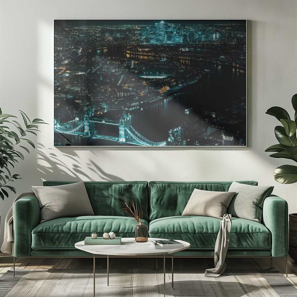 A framed aerial photograph of London at night, featuring the iconic Tower Bridge illuminated in bright teal in the foreground and the glowing skyscrapers of Canary Wharf across the River Thames in the background. Artwork