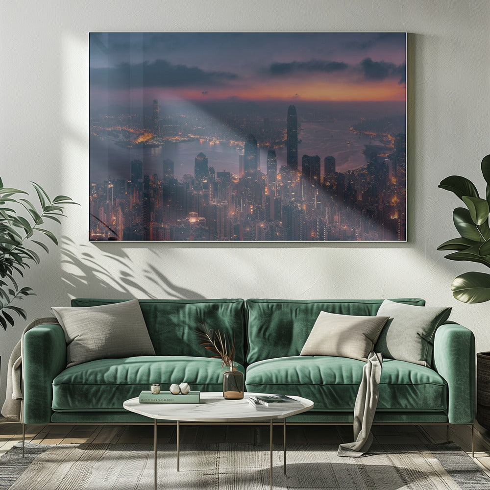 An aerial photograph of a sprawling city skyline at dusk, likely Hong Kong, with countless illuminated skyscrapers. The sky above transitions from a warm orange glow at the horizon to a deep purple, with dark clouds overhead. The city lights cast a golden reflection on the water of the harbor. The entire image is presented within a silver-colored frame. Poster