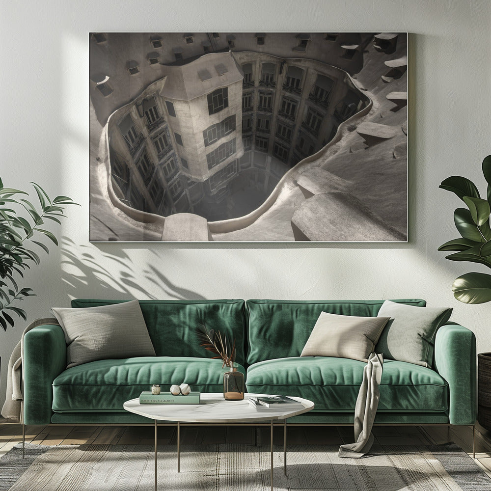 A surreal, high-angle photograph looking down into the distorted, cavernous courtyard of a building. The walls and windows appear to melt and curve inwards towards a dark void, creating a powerful optical illusion. The image has a muted, sepia-toned color palette and is presented in a silver frame. Wall Art