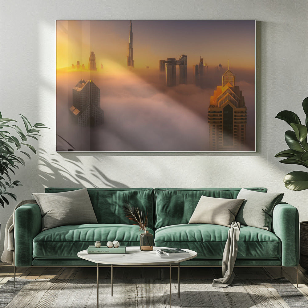 An aerial photograph of the Dubai skyline shrouded in a thick blanket of fog at sunrise. The warm golden light illuminates the tops of several skyscrapers, including the Burj Khalifa, which pierce through the clouds creating a dreamlike and majestic scene. Print