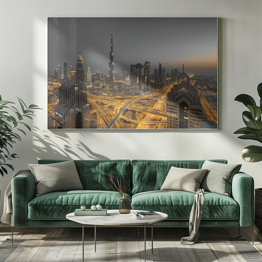 A framed, high-angle, long-exposure photograph of the Dubai skyline at dusk. The towering Burj Khalifa stands out against a grey sky, while the city's skyscrapers are illuminated. In the foreground, a complex network of highways glows with the yellow light trails of traffic, creating intricate patterns. Poster