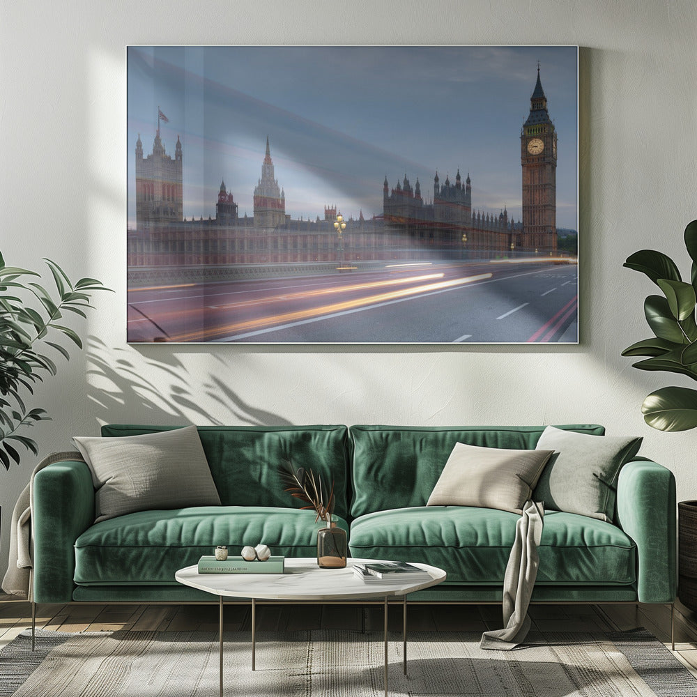 A framed, long-exposure photograph of London's Big Ben and the Houses of Parliament at dusk. In the foreground, streaks of red and yellow light from moving traffic blur across a bridge, creating a dynamic contrast with the historic architecture against a twilight sky. Decor