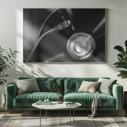 A framed, black and white, close-up photograph of a record player in action. The turntable is spinning a vinyl record, creating a motion blur on the center label. The tonearm and stylus are positioned over the grooved surface of the record. Poster
