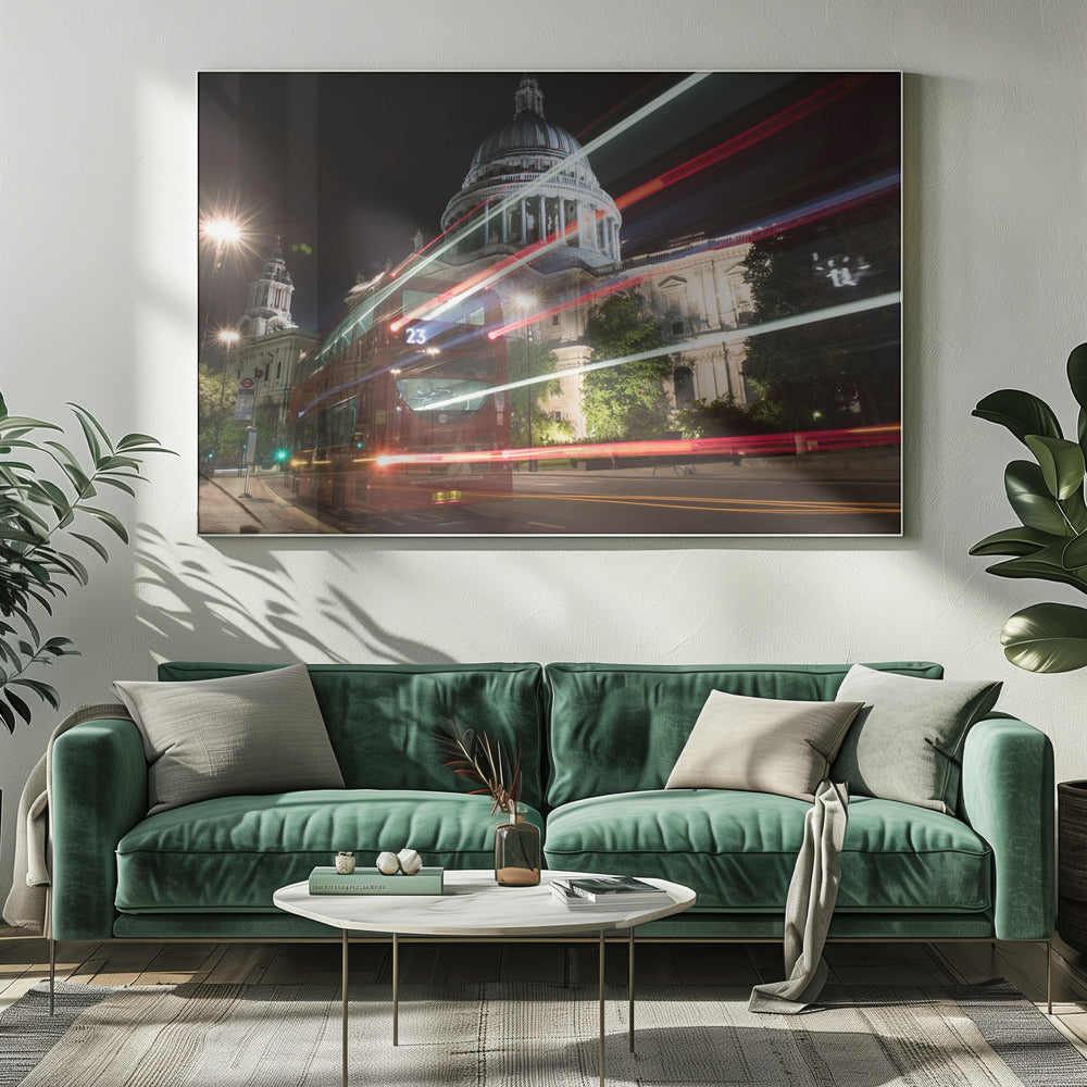 A long-exposure night photograph of a red double-decker bus in London, creating vibrant red and white light trails in front of the illuminated St. Paul's Cathedral. Decor
