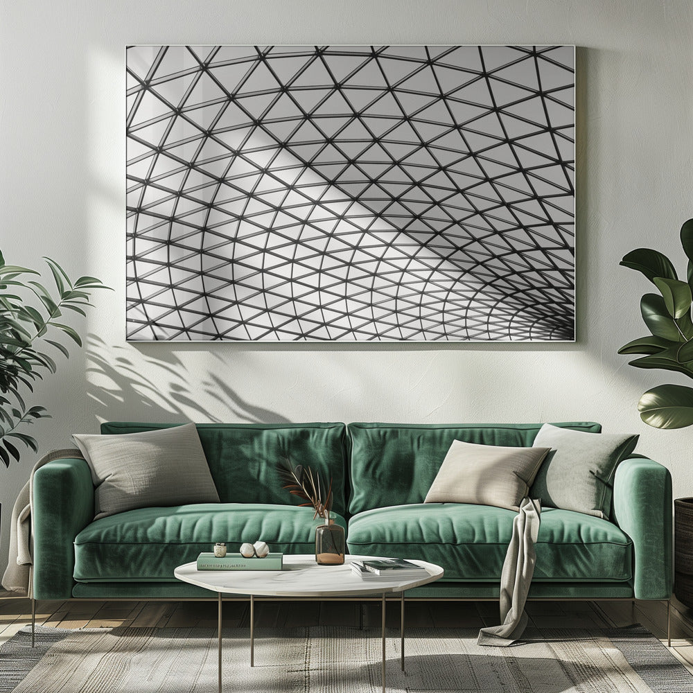 A framed, black and white photograph of a modern architectural dome ceiling. The image is a close-up, looking up at the intricate metal framework that creates a repeating pattern of triangles against the bright glass panels. Poster
