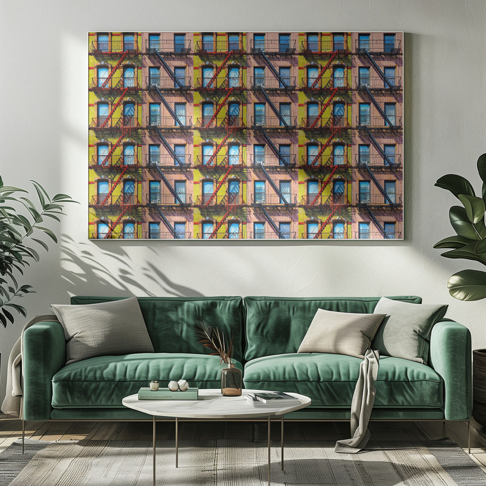 A pop-art style repeating pattern of a colorful apartment building facade featuring pink and yellow walls, windows reflecting a blue sky, and a network of black and red fire escapes, enclosed in a silver frame. Artwork