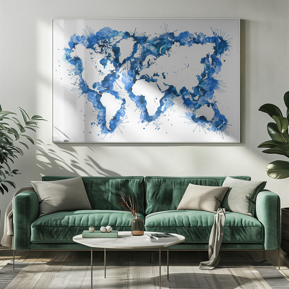 An abstract watercolor world map in a silver frame. The continents are depicted in white negative space, while the oceans are represented by vibrant blue splashes, splatters, and drips of paint on a white background. Artwork