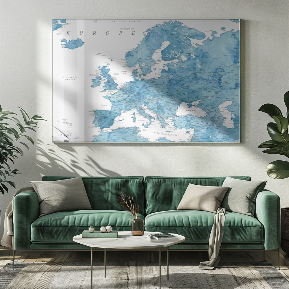 A framed map of Europe with a blue watercolor texture. The land is depicted in various shades of blue, while the oceans are white. Countries, cities, and bodies of water are labeled in black text. The map is housed in a simple, light gray frame. Poster