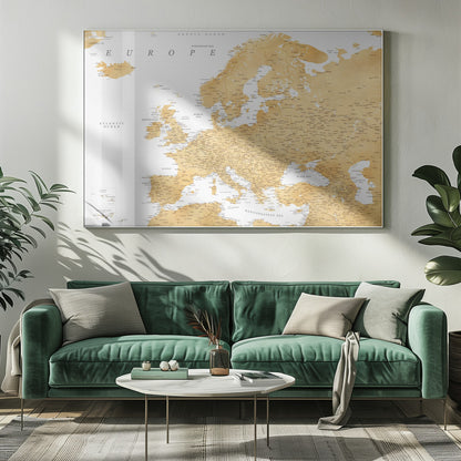 A framed map of Europe featuring golden landmasses on a crisp white background. The map includes country names, major cities, and bodies of water, all presented in a clean, modern font. The artwork is enclosed in a simple, light gray frame. Print