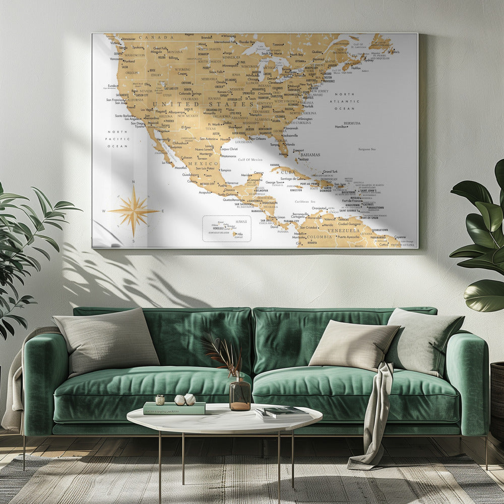 A stylized map of North and Central America and the Caribbean, featuring gold-colored landmasses on a light gray, textured background. Countries, states, and major cities are labeled in black text. A compass rose is shown in the lower-left corner. The entire map is enclosed in a light gray frame. Decor