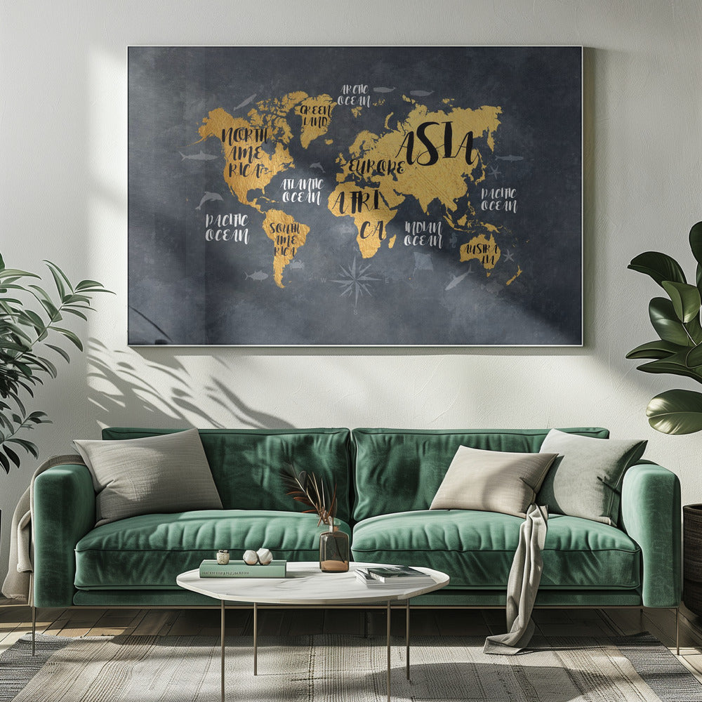 A modern world map artwork with gold leaf continents set against a textured dark gray background. Continents and oceans are labeled with decorative typography, and subtle illustrations of sea life swim in the oceans. The art is presented in a silver frame. Artwork