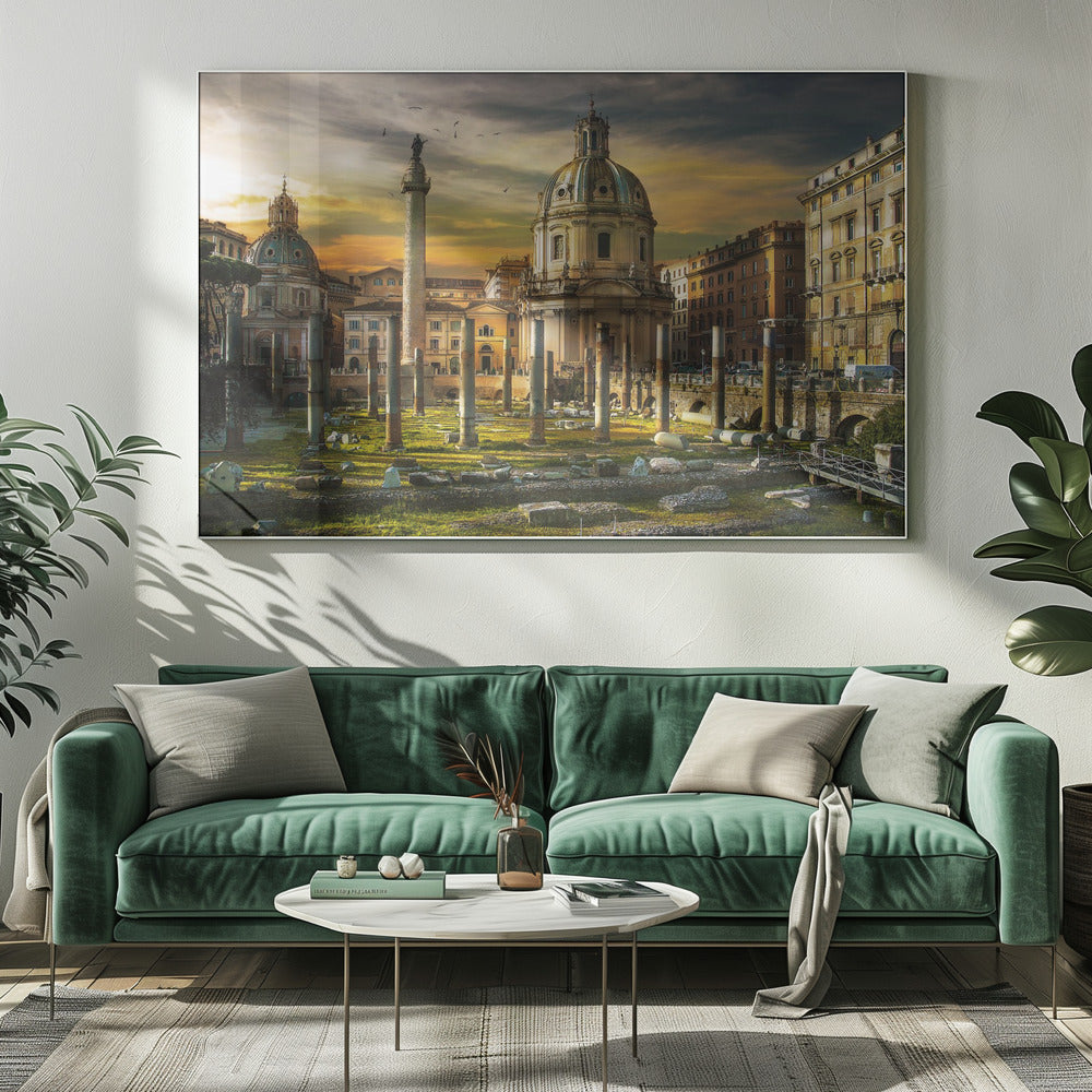 A framed photograph of Trajan's Forum in Rome, Italy, during a dramatic sunset. The foreground is filled with ancient stone columns and ruins on a grassy field, leading to the prominent Trajan's Column and the domed Church of the Most Holy Name of Mary against a golden and dark cloudy sky. Wall Art