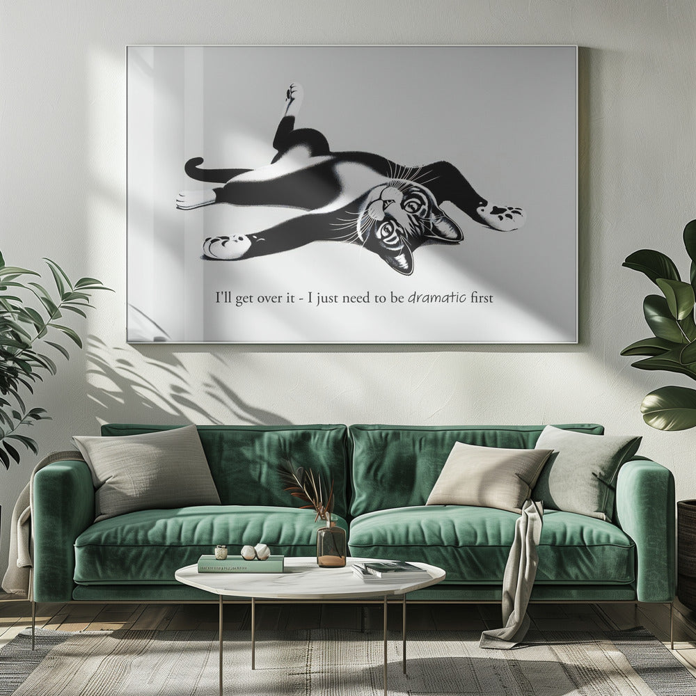 A framed black and white illustration of a tuxedo cat lying playfully on its back. Below the image is the text, 'I'll get over it - I just need to be dramatic first'. Artwork