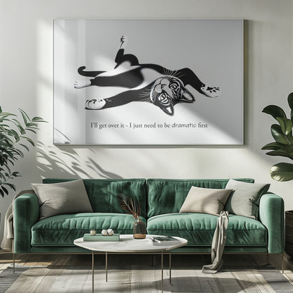 A framed black and white illustration of a tuxedo cat lying playfully on its back. Below the image is the text, 'I'll get over it - I just need to be dramatic first'. Artwork