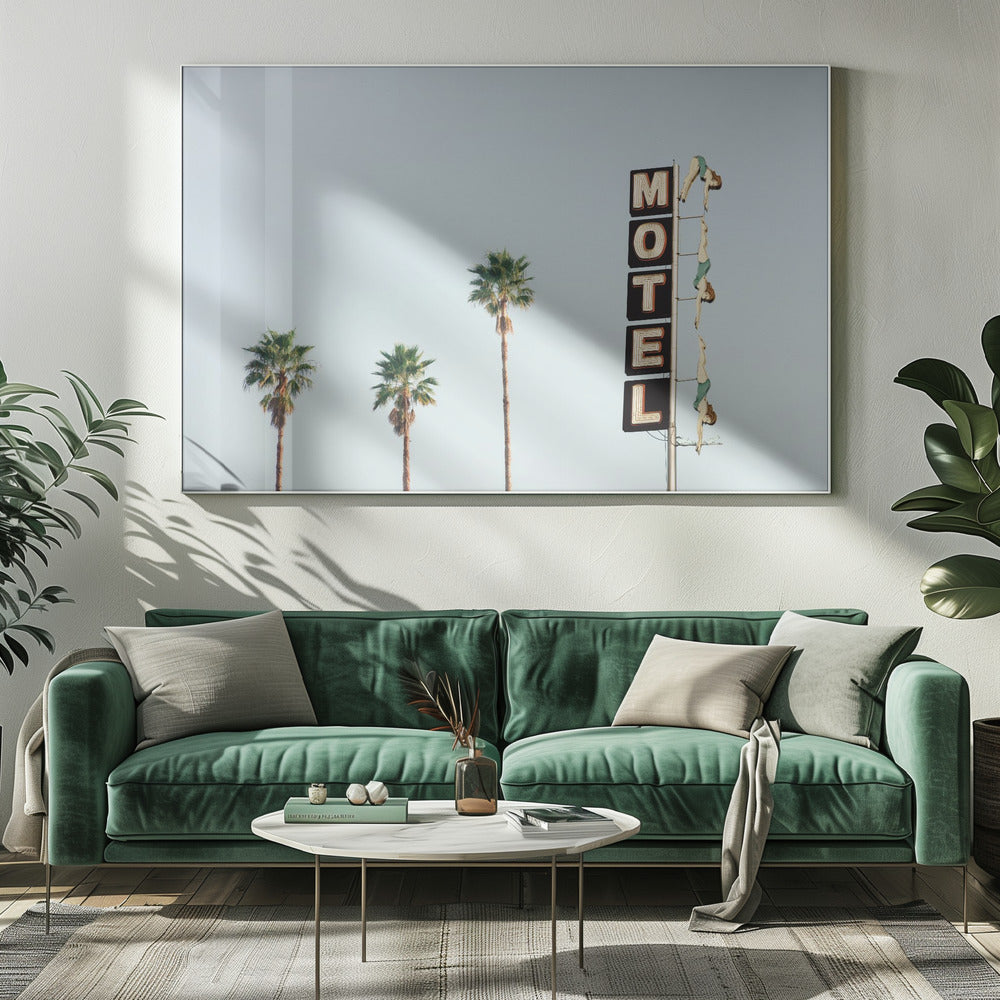 A minimalist photograph featuring three tall palm trees and a vertical black and white 'MOTEL' sign against a pale blue sky. Affixed to the sign's pole are several figures of women in green swimsuits, posed as if diving in a synchronized formation. Poster
