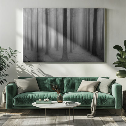 A moody black and white framed photograph of a person walking away through a dense forest on a foggy day. Tall, dark, leafless tree trunks stand in rows, disappearing into the thick, white mist, creating a sense of depth and mystery. Wall Art