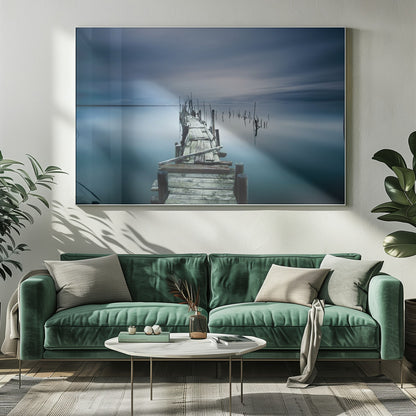 A framed, long exposure photograph of a weathered wooden pier extending into calm, misty blue water under a dramatic, cloudy sky. Wall Art
