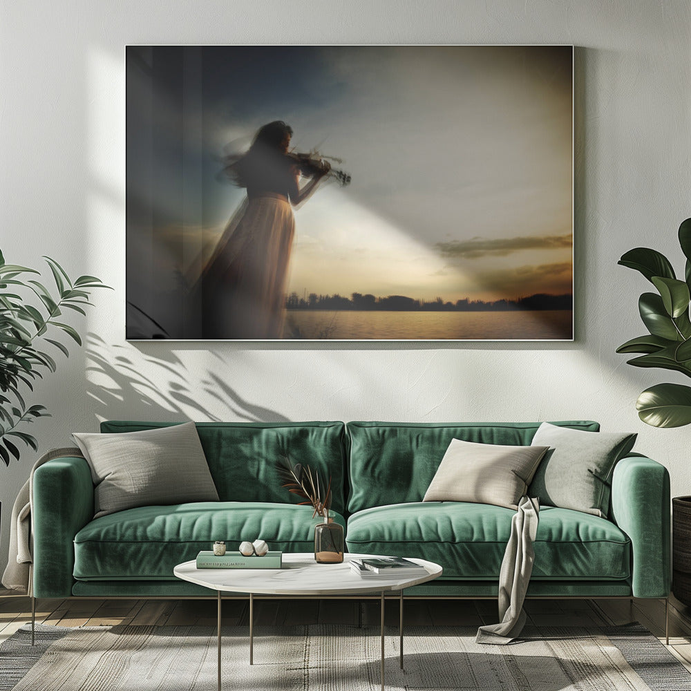 An artistic, framed photograph with motion blur capturing the silhouette of a woman in a long flowing skirt playing the violin by a lake against a dramatic sunset sky. Poster