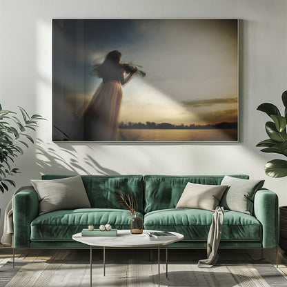 An artistic, framed photograph with motion blur capturing the silhouette of a woman in a long flowing skirt playing the violin by a lake against a dramatic sunset sky. Poster