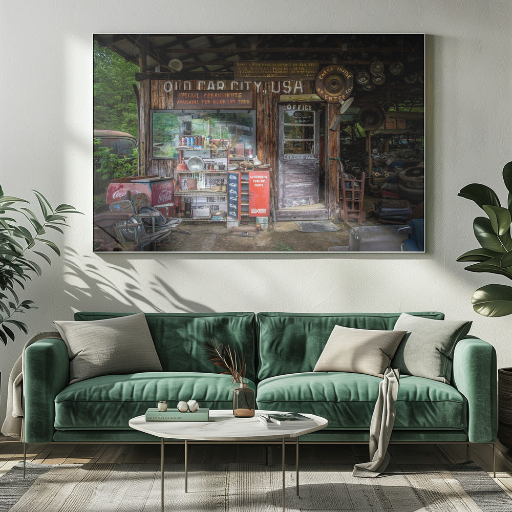 A framed photograph of the cluttered entrance to a rustic wooden building labeled 'Old Car City, USA'. The scene is filled with vintage memorabilia, including car parts, old signs, a red Coca-Cola cooler, and the weathered door to an office. Poster