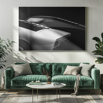 A dramatic black and white studio photograph showcasing the sleek, curved lines of two classic sports cars, with a white car in the foreground and a dark one in the background, set against a black backdrop. Wall Art