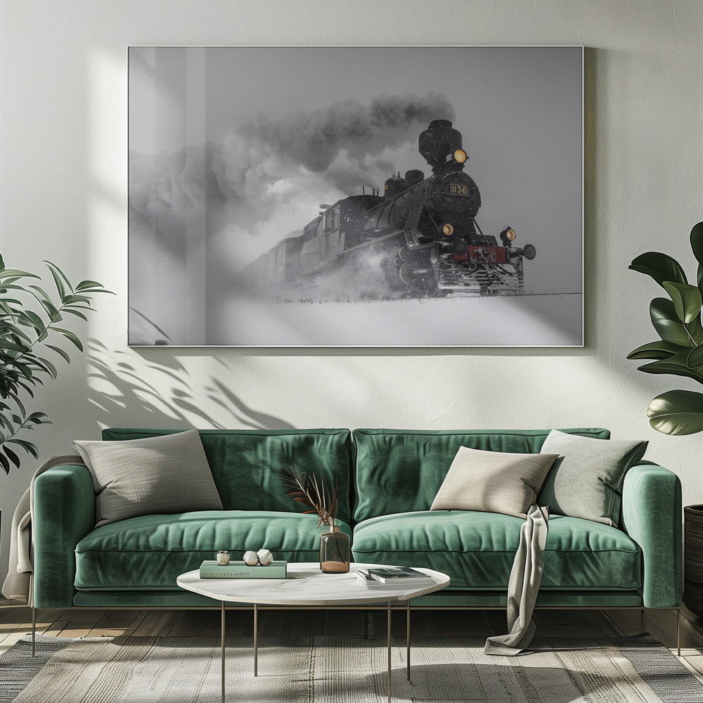 A dramatic black and white photograph of a classic steam train, number 1136, plowing through a heavy snowstorm, with its headlights glowing and a large plume of smoke trailing behind it. The image is presented within a silver frame. Print