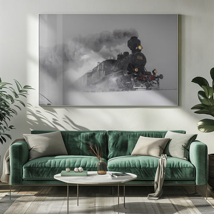 A dramatic black and white photograph of a classic steam train, number 1136, plowing through a heavy snowstorm, with its headlights glowing and a large plume of smoke trailing behind it. The image is presented within a silver frame. Print