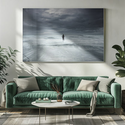 A moody, long-exposure photograph of a silhouetted fisherman standing in the churning white surf of the ocean under a dark, stormy sky, presented in a silver frame. Wall Art