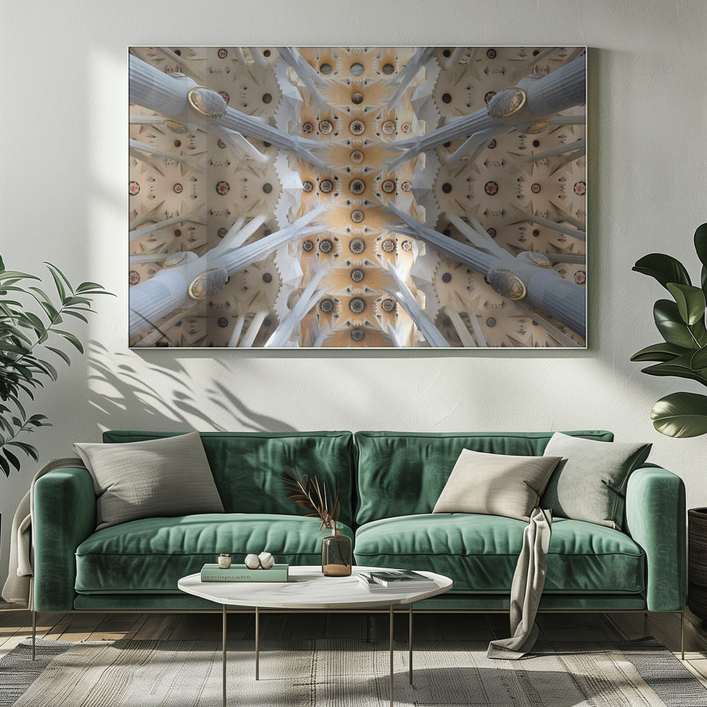 A symmetrical photograph looking directly up at the ornate, geometric ceiling of the Sagrada Familia. White, tree-like columns branch out to support the intricate vaulted ceiling, which is detailed with warm orange and gold starburst patterns. Decor