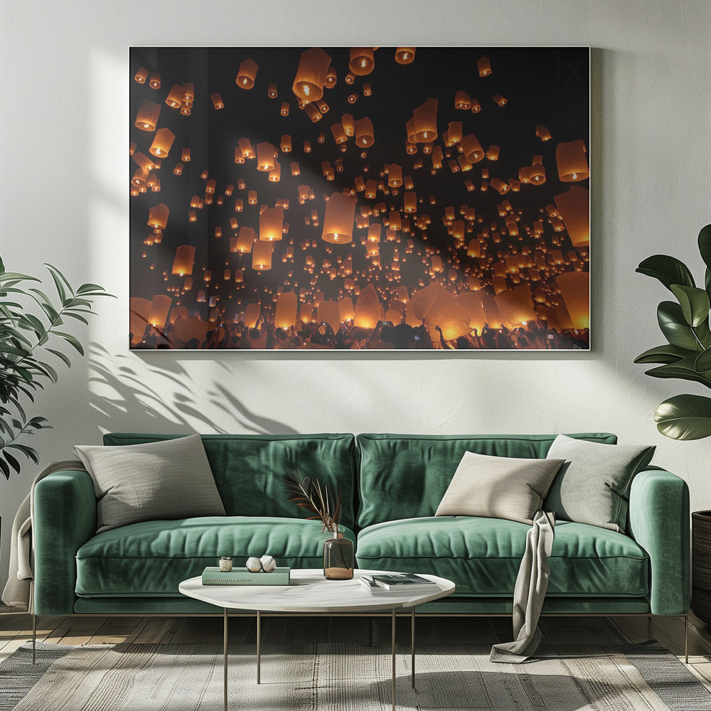 A framed photograph of a sky lantern festival at night, with hundreds of warm, orange-glowing lanterns floating up into the pitch-black sky from a crowd of people below. Artwork