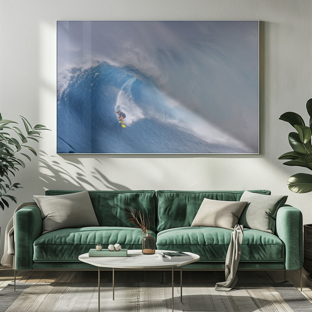 A framed photograph of a professional surfer skillfully riding down the steep face of a massive, cresting blue ocean wave, surrounded by white sea spray. Decor