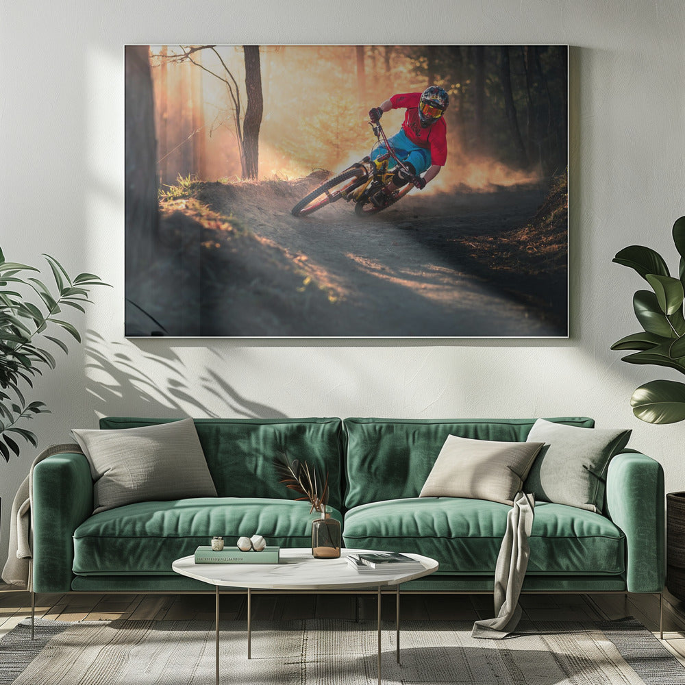 A mountain biker in a red shirt, blue shorts, and full-face helmet leans sharply into a dusty turn on a dirt trail in a forest. The setting sun casts a warm, golden light through the trees, creating a dramatic, backlit effect. Wall Art
