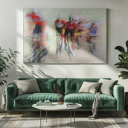 An abstract photograph of a group of cyclists in a race, captured with motion blur to create a dynamic sense of speed. The riders' red jerseys and the green background are streaked together, with a silver frame surrounding the image. Artwork