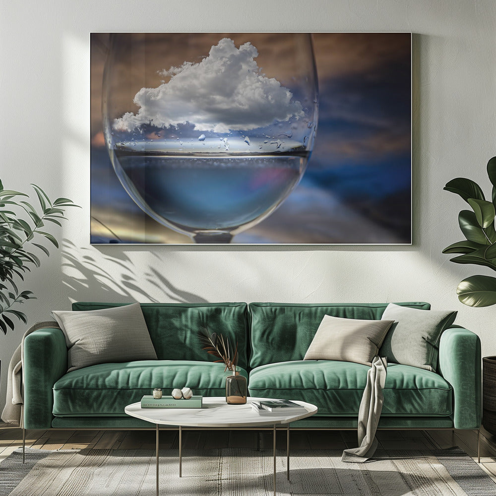 A surreal close-up of a wine glass holding blue liquid and a single white cloud, with water droplets on the glass, set against a blurred background and enclosed in a silver frame. Print