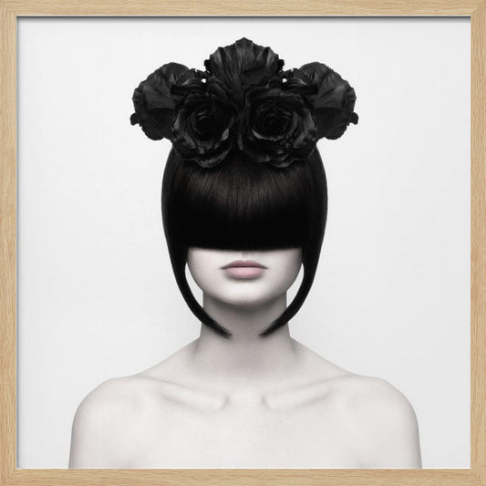 A stylized black and white portrait of a woman with a sleek black bob hairstyle where the bangs completely cover her eyes. She wears a large, elaborate headpiece made of black roses. Her expression is neutral, showing only her mouth and chin. The image is set against a plain white background and enclosed in a light wood frame. Print