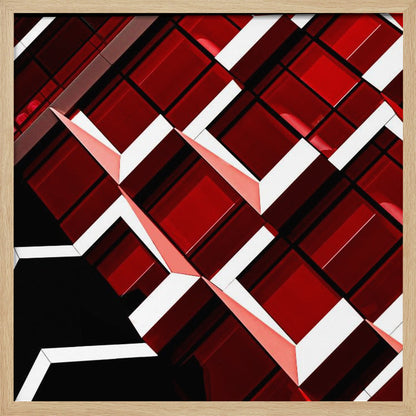 A close-up, angular photograph of a modern building's facade, framed in light wood. The composition is a dynamic geometric pattern of glossy red square panels, stark white lines, and deep black shadows, creating a sense of depth and abstract complexity. Wall Art