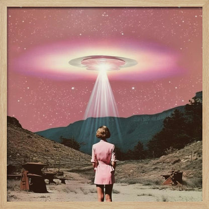A vintage-style collage artwork in a wood frame depicting a woman in a pink dress standing in a desert landscape, looking up at a large UFO hovering in a pink, starry sky and beaming down a bright light. Print