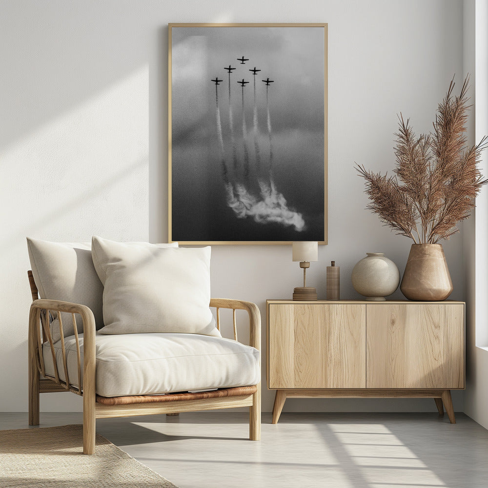 A grainy black and white photo of six airplanes flying in a V-formation against a cloudy sky. Each plane leaves a long, white smoke trail that billows at the bottom of the frame. The image is presented within a black border. Print