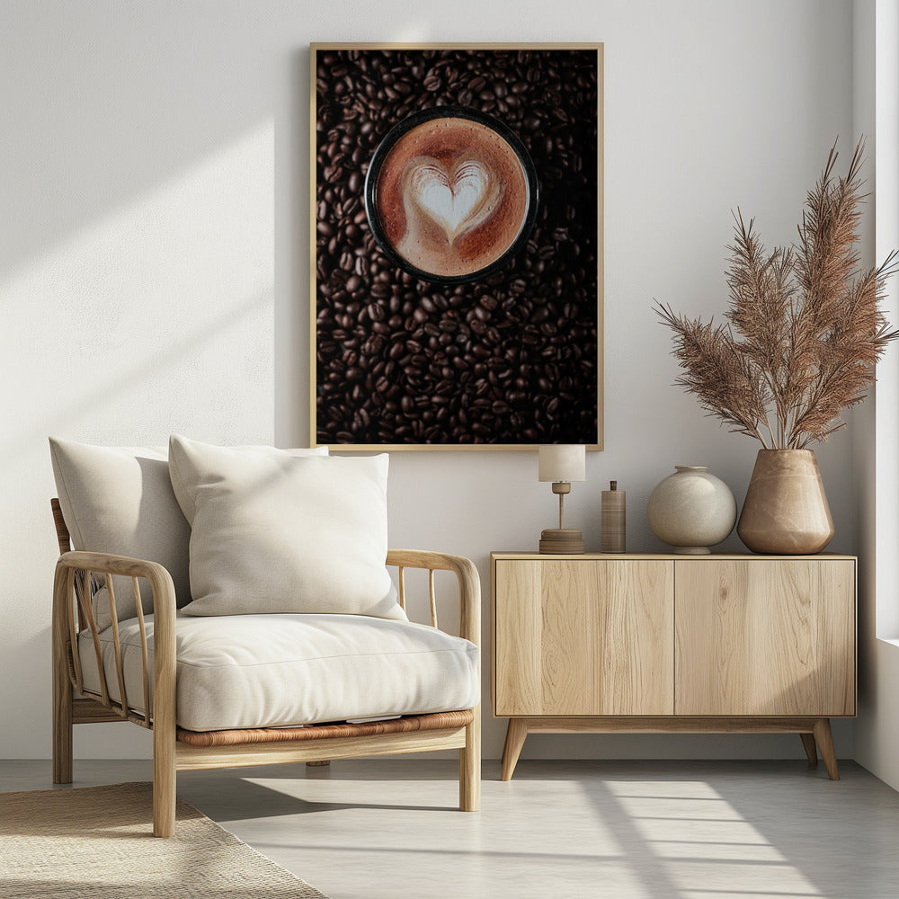 A top-down view of a cappuccino in a black mug with a white heart-shaped foam art design, placed on a bed of dark roasted coffee beans. Artwork