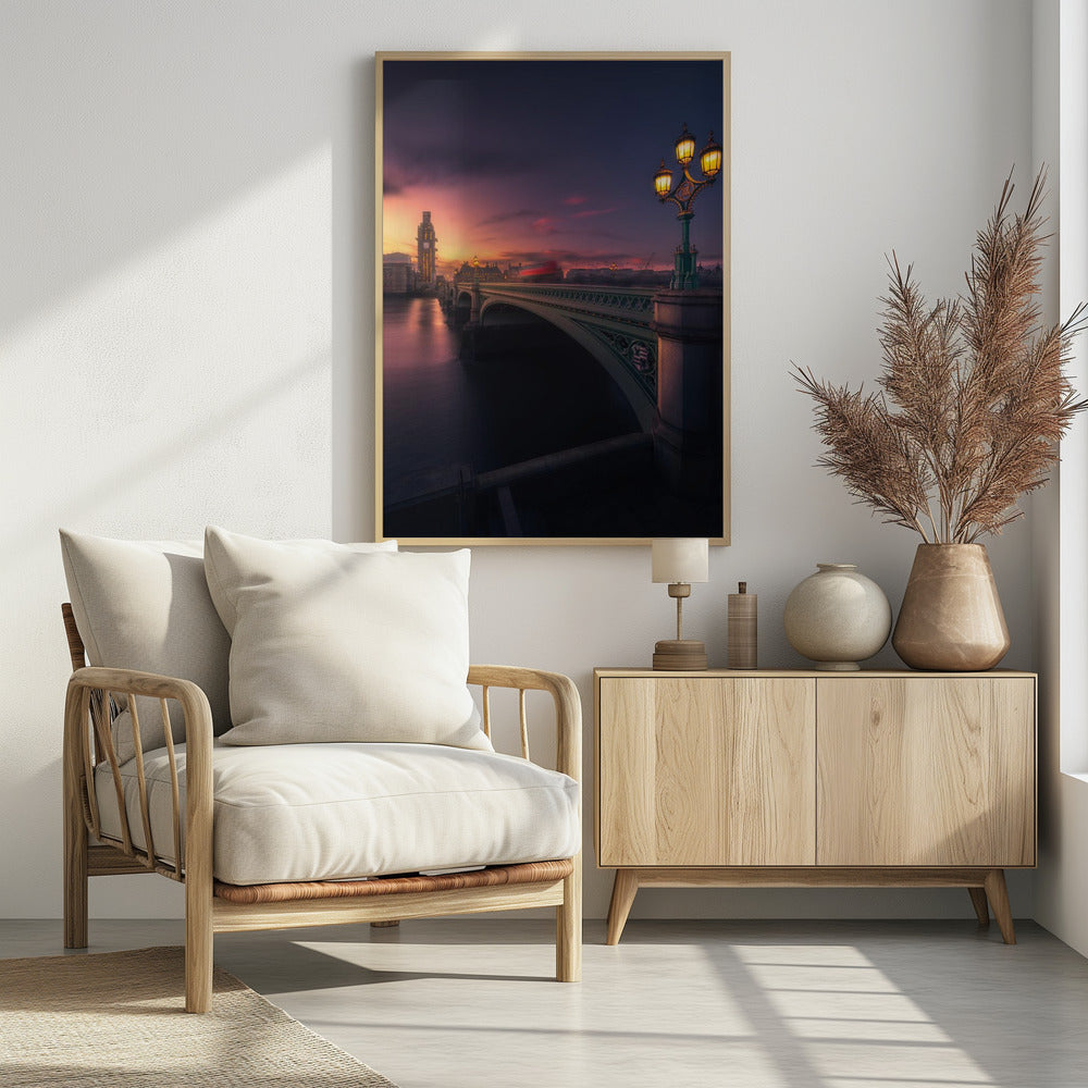 A breathtaking twilight view of Westminster Bridge in London, with the iconic Big Ben illuminated in the background against a purple and orange sunset sky. A vintage street lamp glows warmly in the foreground, and the motion blur of a red bus crosses the bridge over the calm River Thames. Print