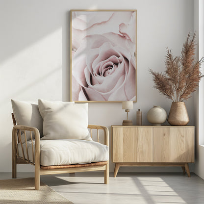 A tightly cropped, macro photograph of a dusty pink rose in a black frame, with its soft petals spiraling inward. Print