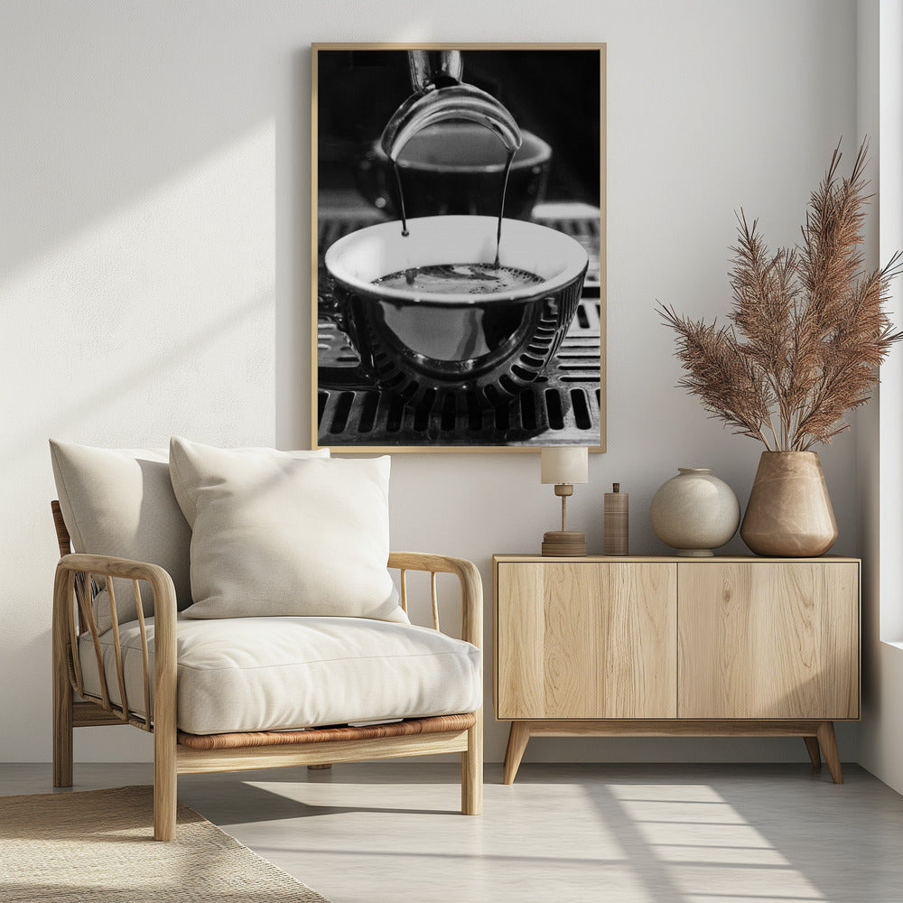 A close-up, black and white artistic photograph capturing the moment two streams of dark espresso pour from a portafilter into a waiting cup on a coffee machine's drip tray. Wall Art