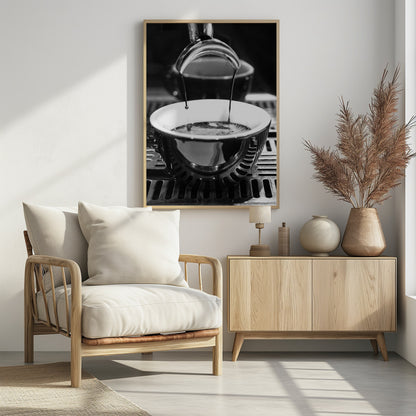 A close-up, black and white artistic photograph capturing the moment two streams of dark espresso pour from a portafilter into a waiting cup on a coffee machine's drip tray. Wall Art