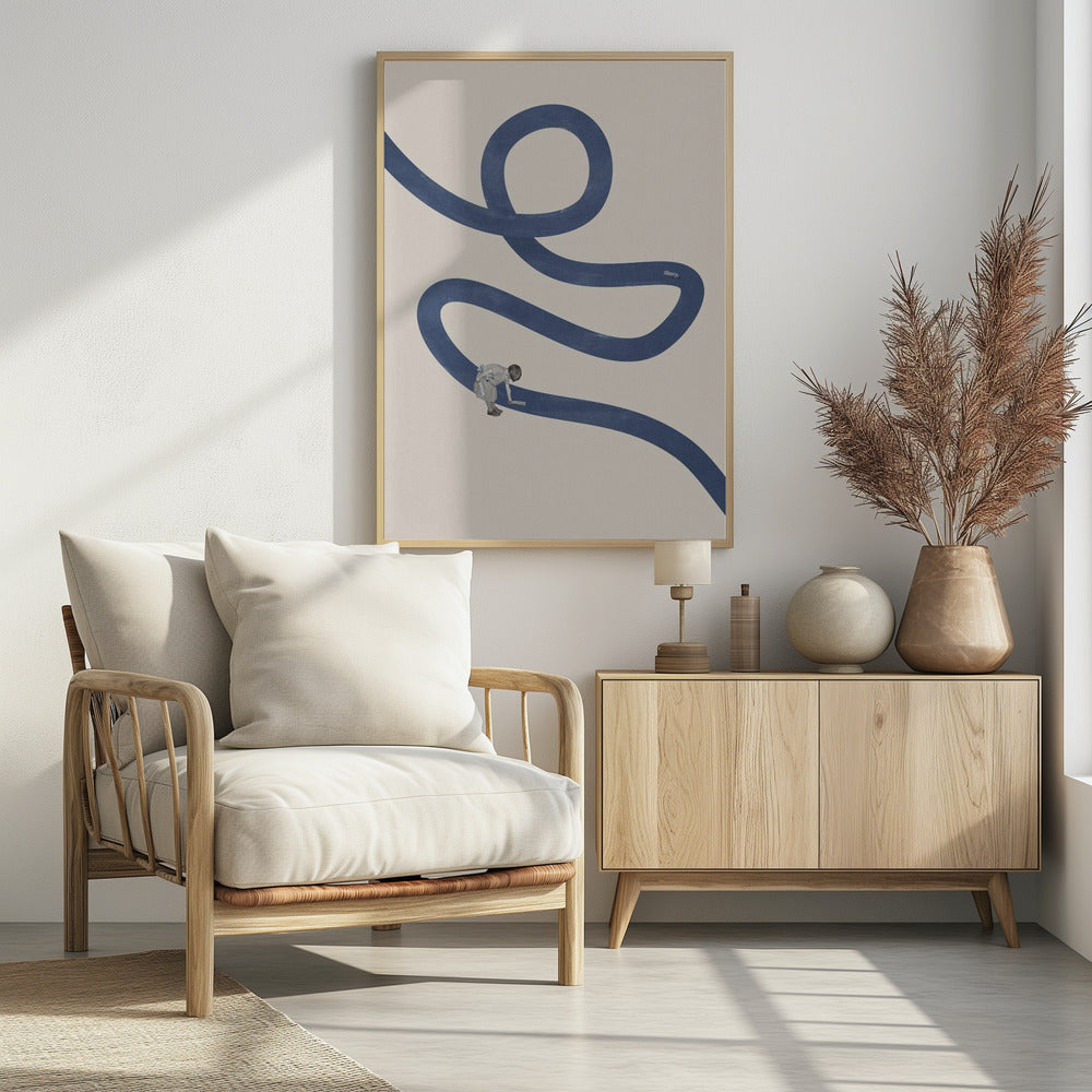 A minimalist collage artwork featuring a thick, winding blue path on a textured beige background. In the lower half, a small child is shown leaning over and appearing to paint the blue path with a roller, creating a surreal and imaginative scene. The artwork is presented in a thin black frame. Decor