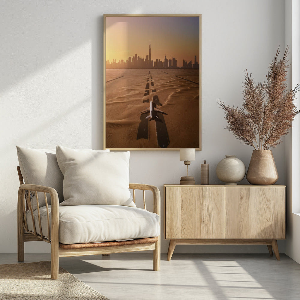 A surreal high-angle view of a white airplane on a runway partially buried in desert sand, pointing towards the Dubai city skyline during a hazy orange sunset. Decor