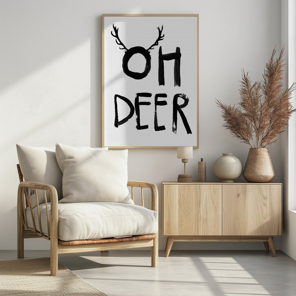A black and white minimalist art print featuring the phrase 'OH DEER' painted in a bold, black brushstroke font. The letter 'O' is playfully adorned with a pair of deer antlers, creating a visual pun. Decor