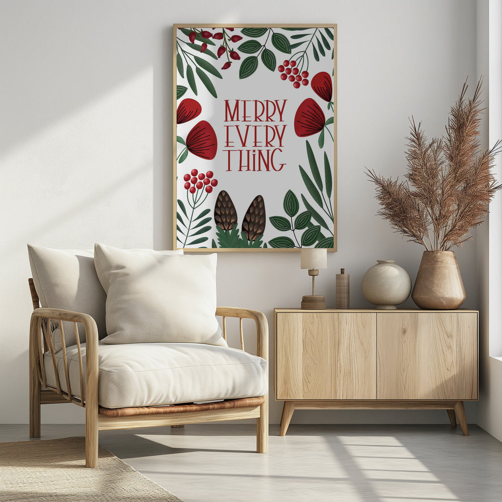 A framed holiday art print with a white background. In the center, the words 'MERRY EVERYTHING' are written in a stylized red serif font. The text is surrounded by a border of illustrated winter botanicals, including red flowers, green leaves, red berries, and brown pinecones. Print