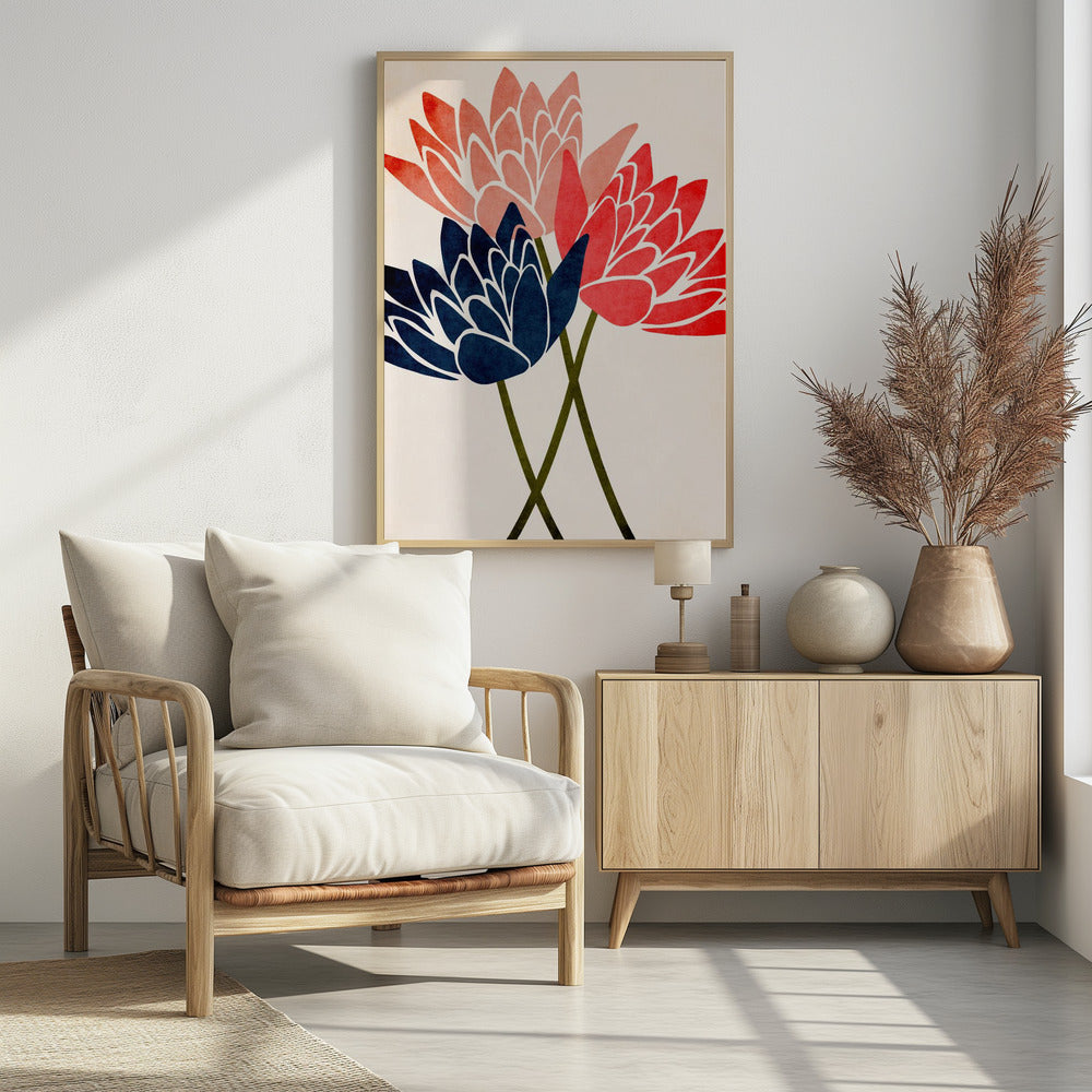 A modern graphic art print of three stylized flowers in navy blue, coral red, and salmon pink against a textured off-white background, all enclosed in a thin black frame. The flower petals have white outlines, and their dark green stems cross at the bottom. Artwork