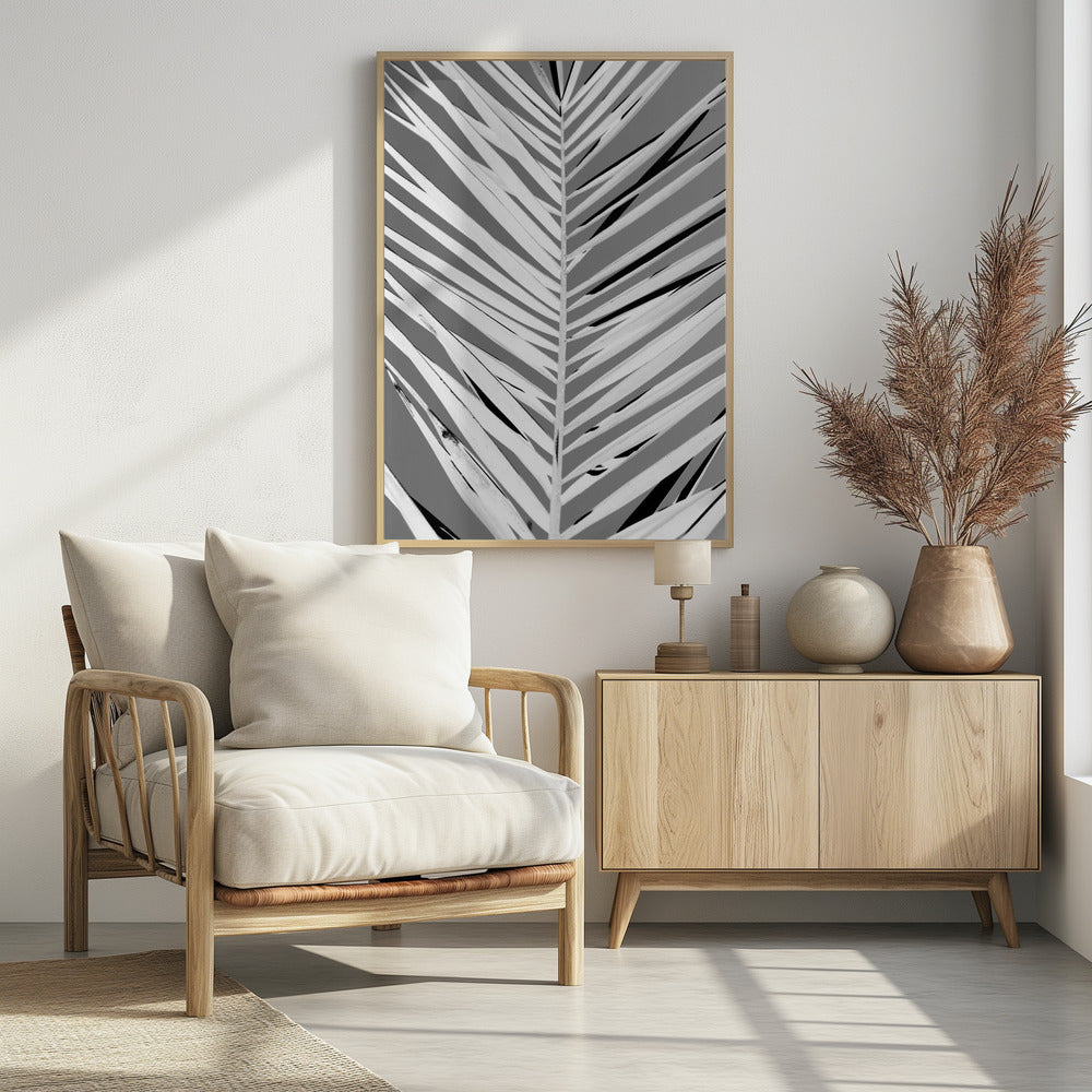 A high-contrast, black and white close-up photograph of a palm frond. The central stem runs vertically through the frame, with the individual leaves creating a dynamic pattern of diagonal white and gray stripes, accented by deep black shadows. The entire image is presented within a thin black frame. Print