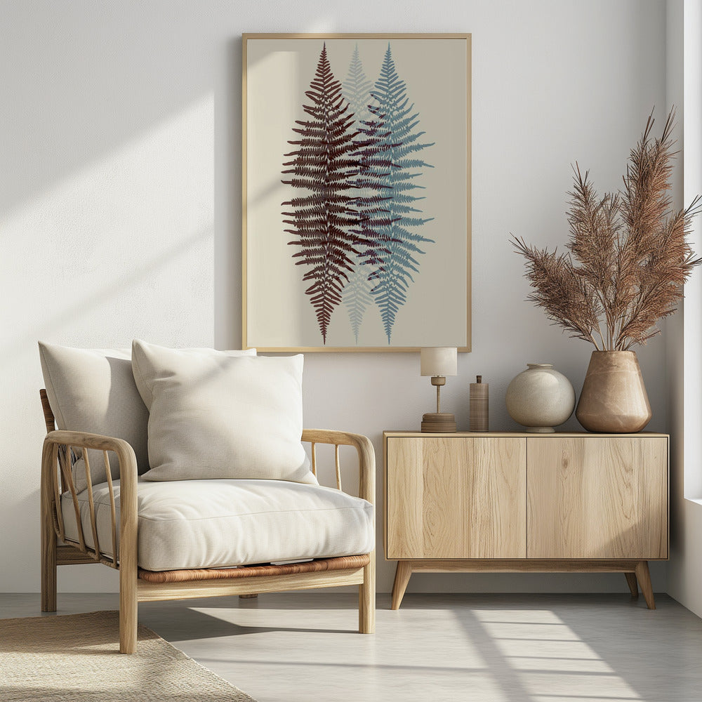 A modern botanical art print featuring three overlapping fern fronds against a cream background. The frond on the left is reddish-brown, the one on the right is blue, and a fainter blue frond is visible in the middle, creating a layered, translucent effect. The entire piece is enclosed in a simple black frame. Wall Art